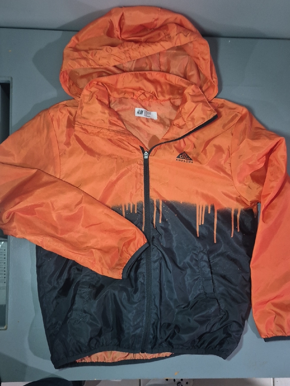 H&M Kids Orange and Black Hooded Rain Jacket with Drip Graphic